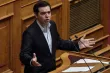 Greek Prime Minister Alexis Tsipras delivers a speech to the Greek parliament in Athens on January 15, 2018, ahead of a parliamentary vote on controversial reforms demanded by Greece's creditors, including curbs on industrial action. / AFP PHOTO / LOUISA GOULIAMAKI


