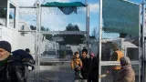 Des migrants avec un bébé sortent du camp migratoire de Moria, deuxième "ville" de l'île de Lesbos, le 21 décembre 2017 en Grèce


