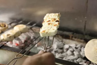 Le halloumi peut-il réconcilier les Chypriotes ? Un restaurateur fait griller du halloumi à Nicosie, le 2 avril 2021. REUTERS/Yiannis Kourtoglou