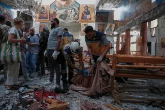 Des membres de la défense civile syrienne enlèvent des corps à l'intérieur de l'église Mar Elias à Dweila, dans la banlieue de Damas, le 22 juin 2025. OMAR SANADIKI / AP