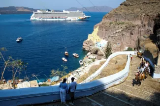 Un bateau de croisière près du village de Fira, sur l'île grecque de Santorin, le 20 juillet 2024  -  ARIS OIKONOMOU - Grèce (AFP)