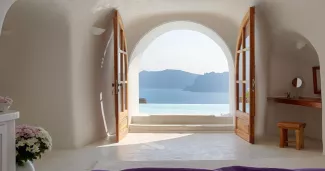 Piscine à débordement et suites troglodytes plongent dans la caldeira de Santorin : un balcon suspendu au‑dessus de la mer Égée, taillé pour les escapades à deux. Photo presse