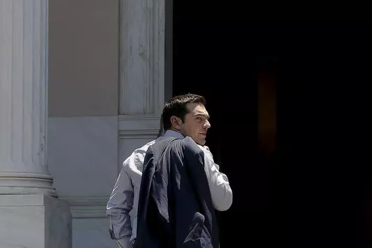 Greek Prime Minister Alexis Tsipras looks on as he arrives at this office at Maximos Mansion in Athens June 20, 2015. Greece will try to bring more to the table in negotiations for a debt deal and Tsipras will probably speak with European Commission chief Jean-Claude Juncker by phone on Saturday to try to end the deadlock, a Greek minister said. REUTERS/Alkis Konstantinidis


