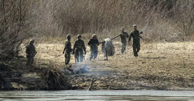 Des militaires grecs installent des barbelés sur les rives du fleuve Maritsa qui marque la frontière avec la Turquie.


