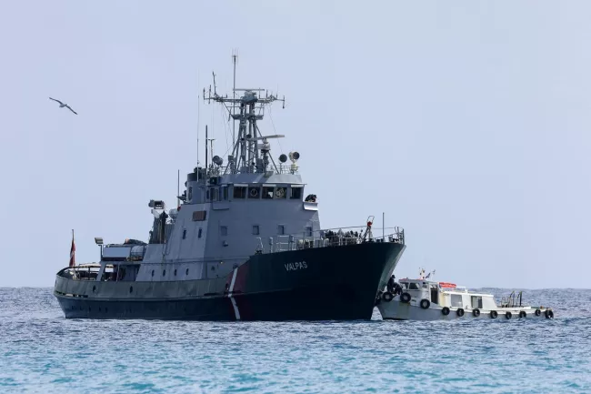 Un transfert de migrants secourus en mer, d’un navire de Frontex vers un plus petit bateau, au large de la Crète (Grèce), le 21 février 2026. STEFANOS RAPANIS/REUTERS