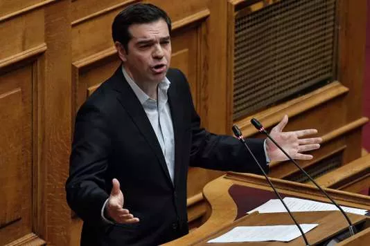 Greek Prime Minister Alexis Tsipras delivers a speech to the Greek parliament in Athens on January 15, 2018, ahead of a parliamentary vote on controversial reforms demanded by Greece's creditors, including curbs on industrial action. / AFP PHOTO / LOUISA GOULIAMAKI


